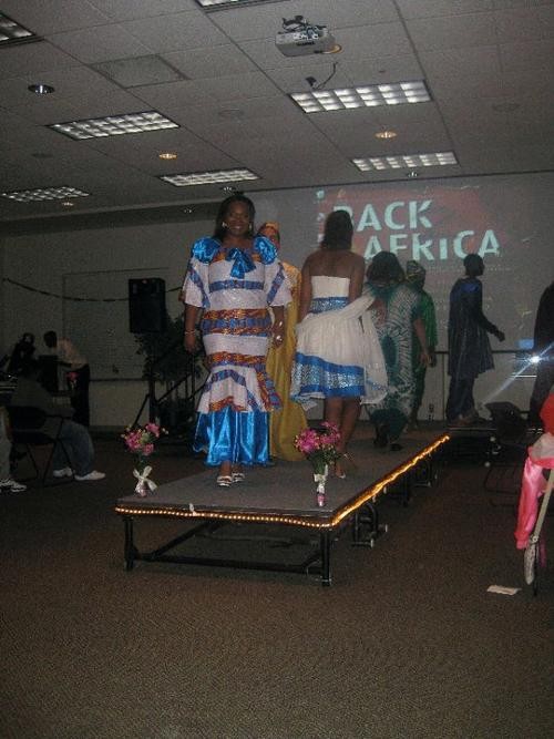 Fashion show with two people on stage with blue and white dresses